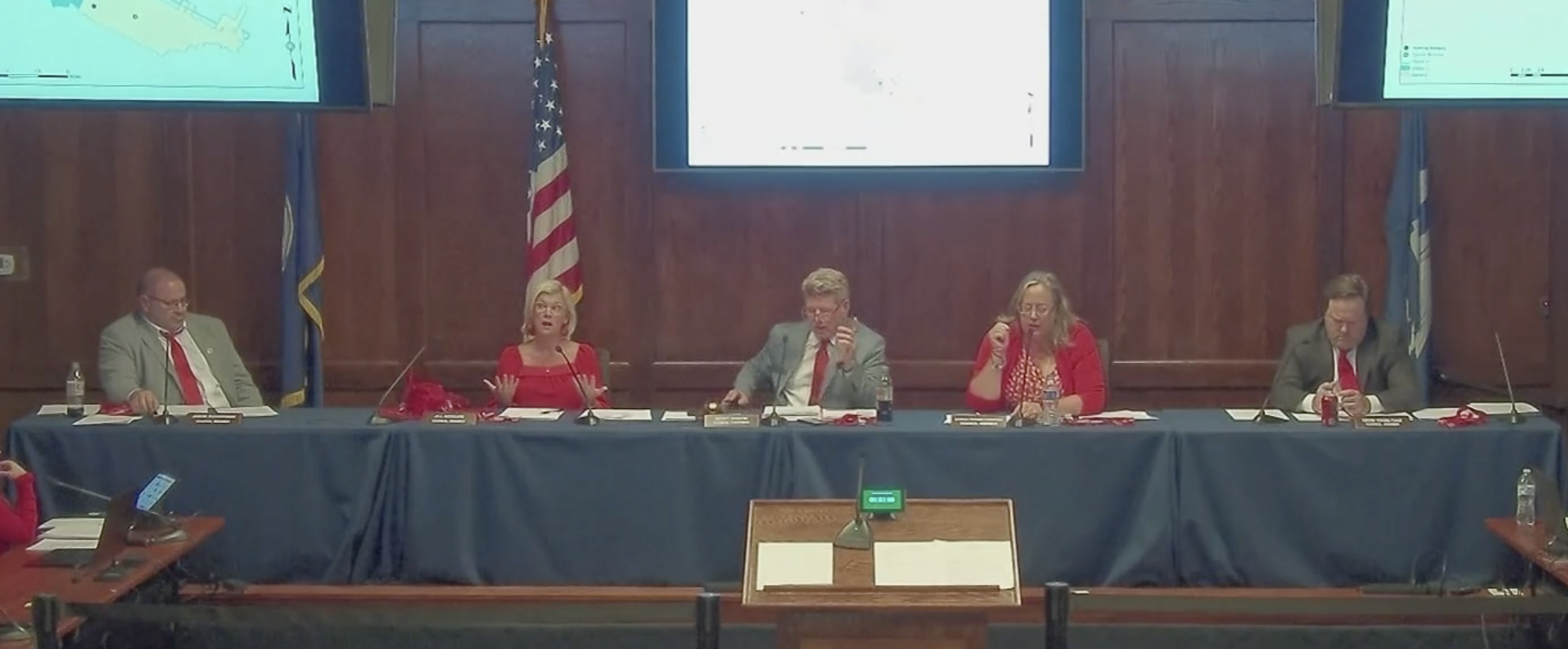 District III Councilwoman Jill McGuire sits stunned and frozen after being interrupted by District I Councilwoman Cynthia Strong-Thompson and silenced by Councilman at Large Scott Discon at the October 24th City Council Meeting (Mandeville Daily).