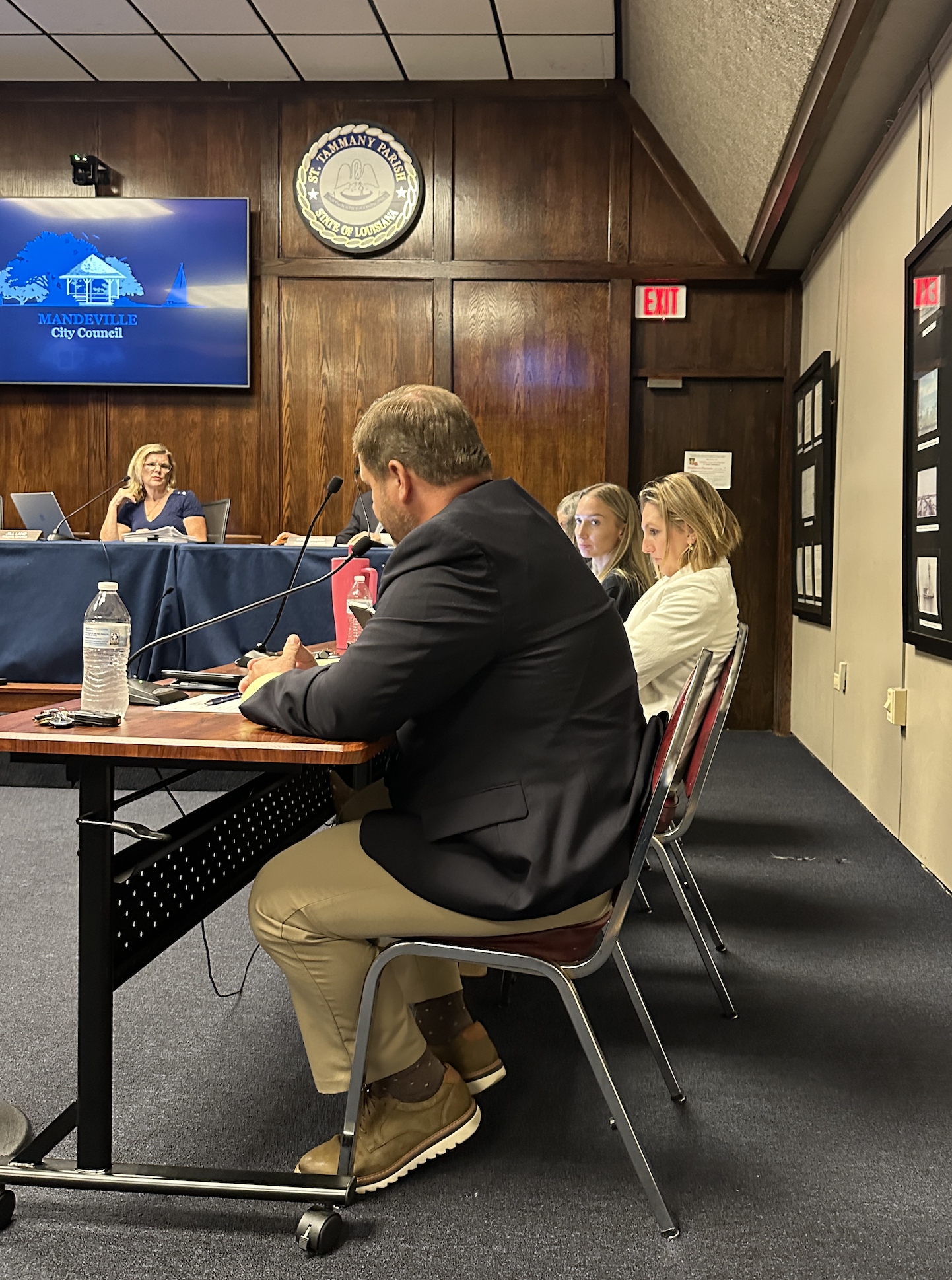 Mayor Clay Madden fields a question from District III Councilwoman Jill Lane as Finance Director Jessica Farno looks on. (Mandeville Daily)